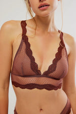 This low cut, lace-trimmed bralette is perfect for low-cut tops. The mesh material is stretchy and covered in sweet brown polka dots. Shop all bras and intimates for women. Visit our clothing store in Providence, Rhode Island.